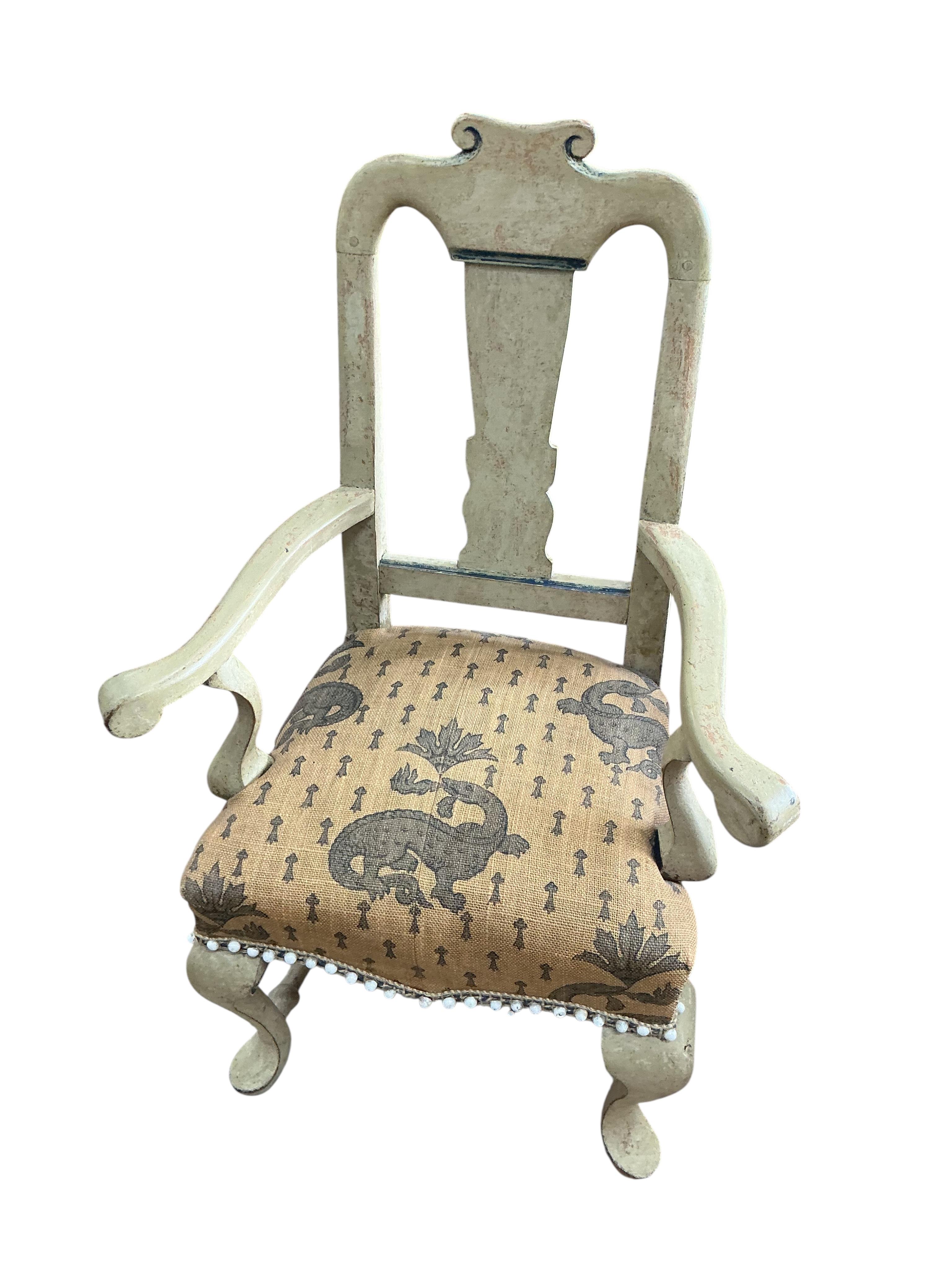A painted George I style child's elbow chair, width 48cm, depth 33cm, height 78cm together with a giltwood child's chair with floral tapestry seat